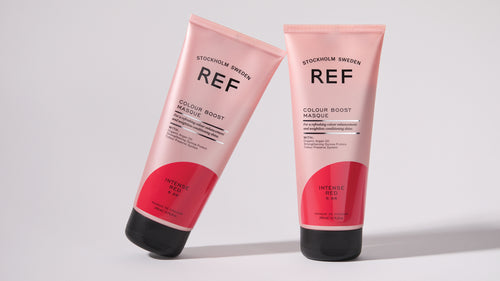 Two tubes of Colour Boost Masque Intense Red. One leaning agains the other.